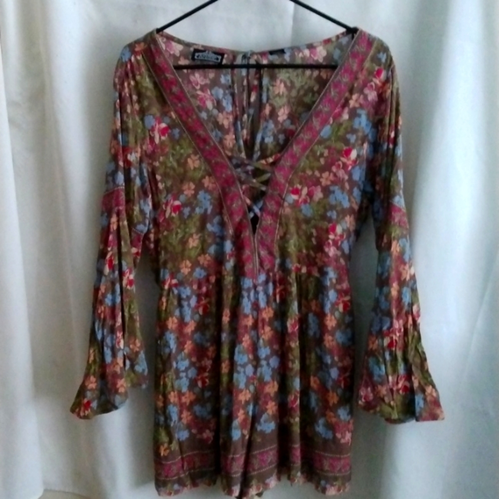 A multicolored floral patternd Angie brand romper size medium.